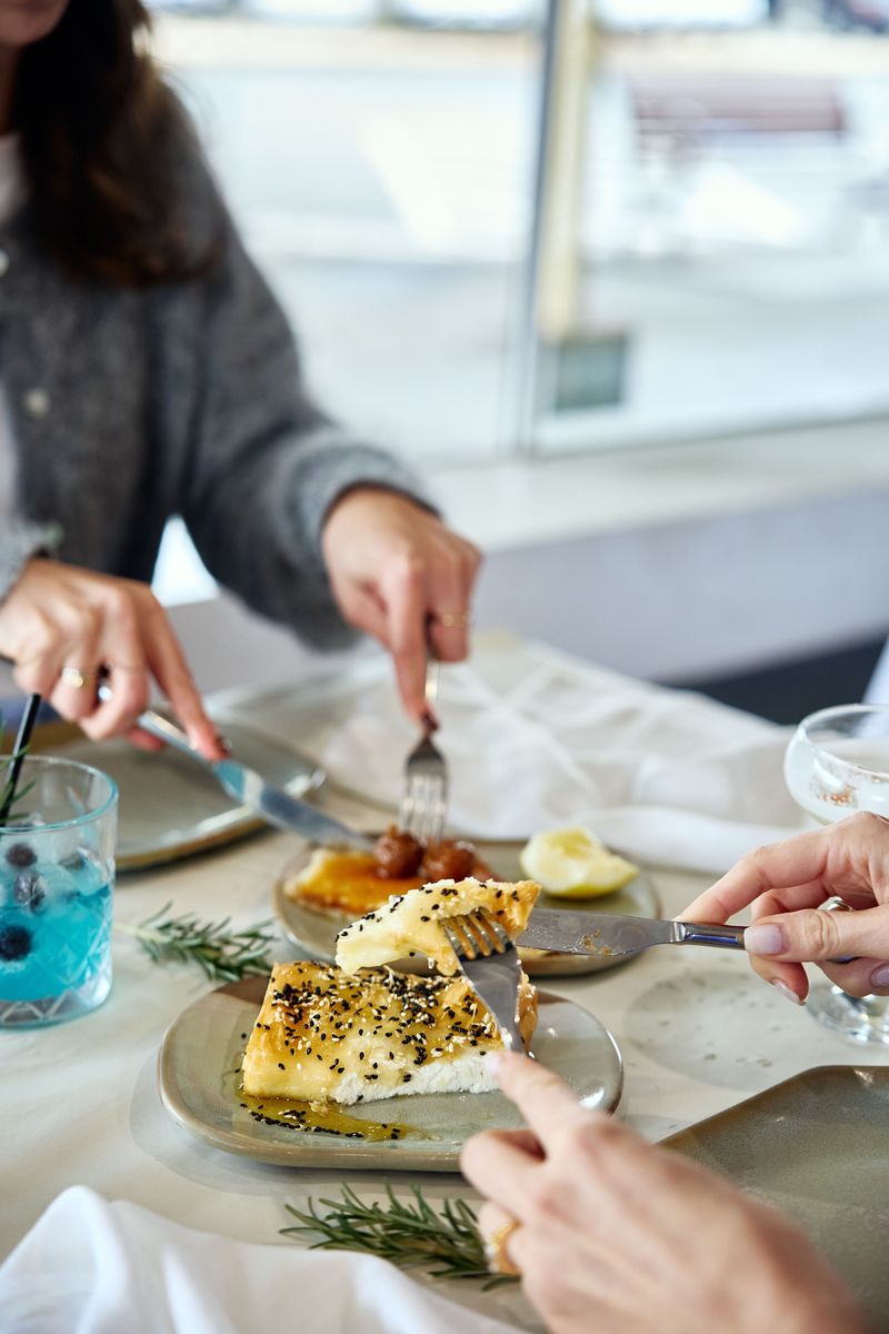Guests sharing saganaki at OPA Echuca